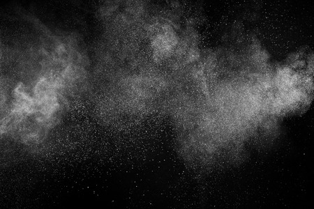 White dust in the air on a black background