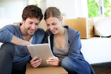 Man and woman searching on a tablet for a floor removal company